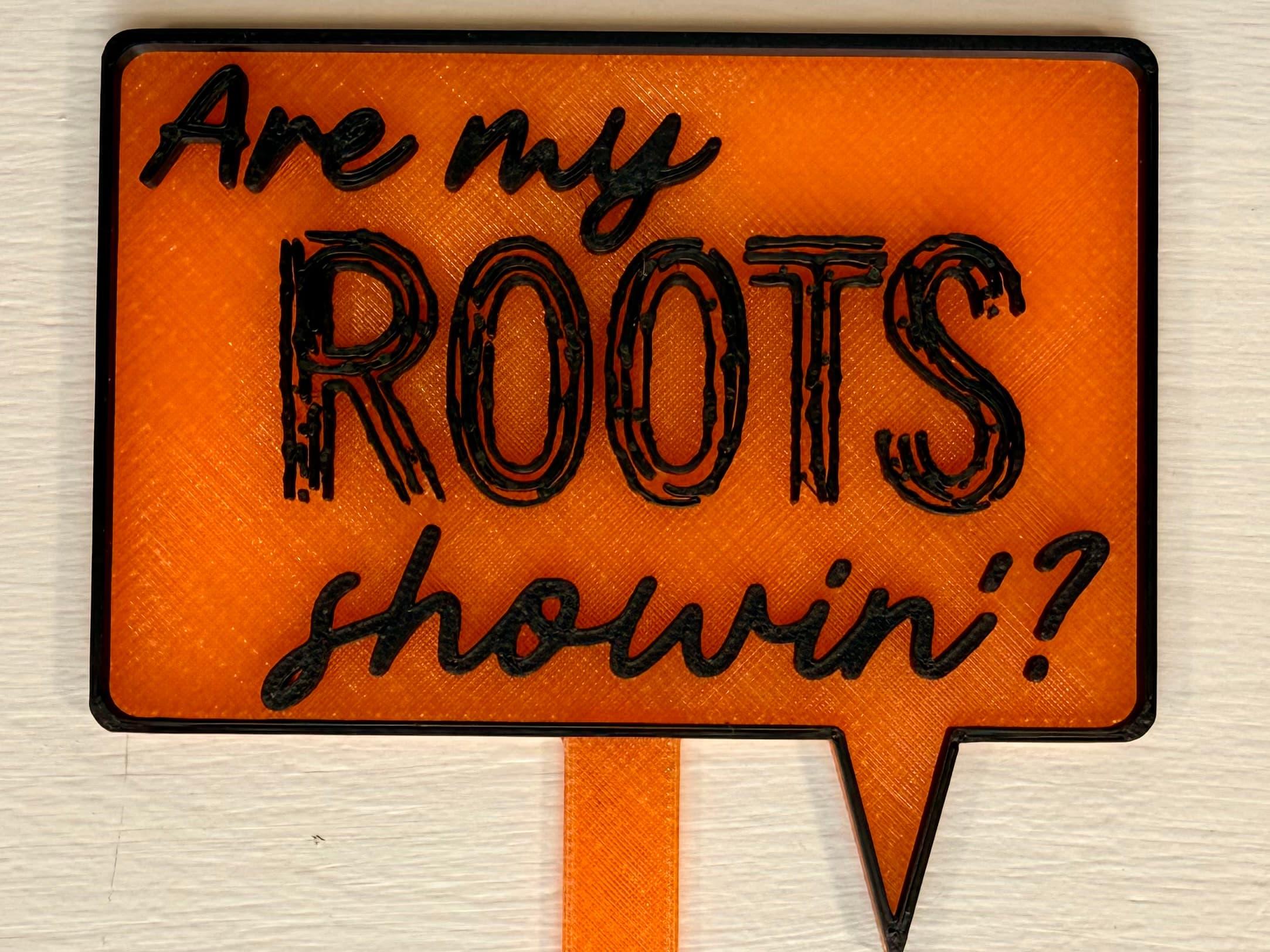 3D-printed pot pick with raised text reading 'Are My Roots Showin'?'