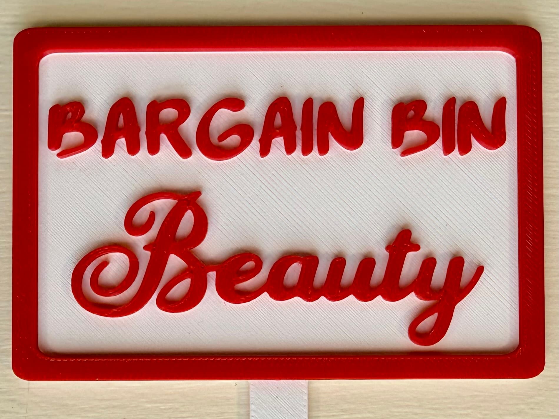 3D-printed pot pick with raised text reading 'Bargain Bin Beauty'