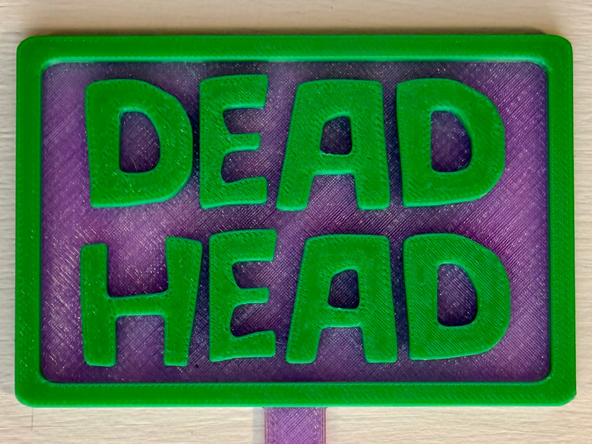 3D-printed pot pick with raised text reading 'Dead Head'