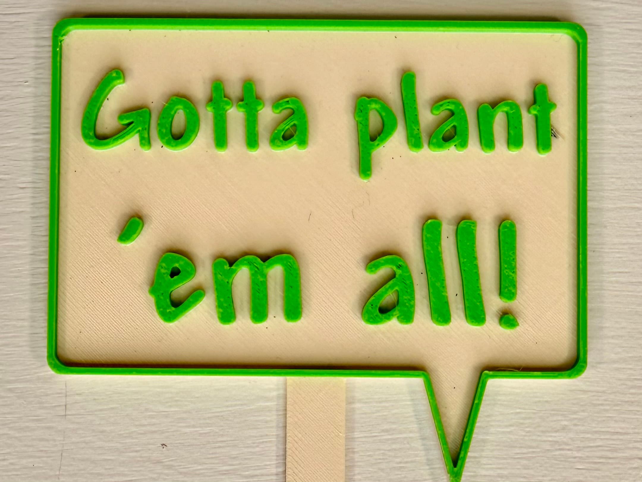 3D-printed pot pick with raised text reading 'Gotta Plant 'Em All!'