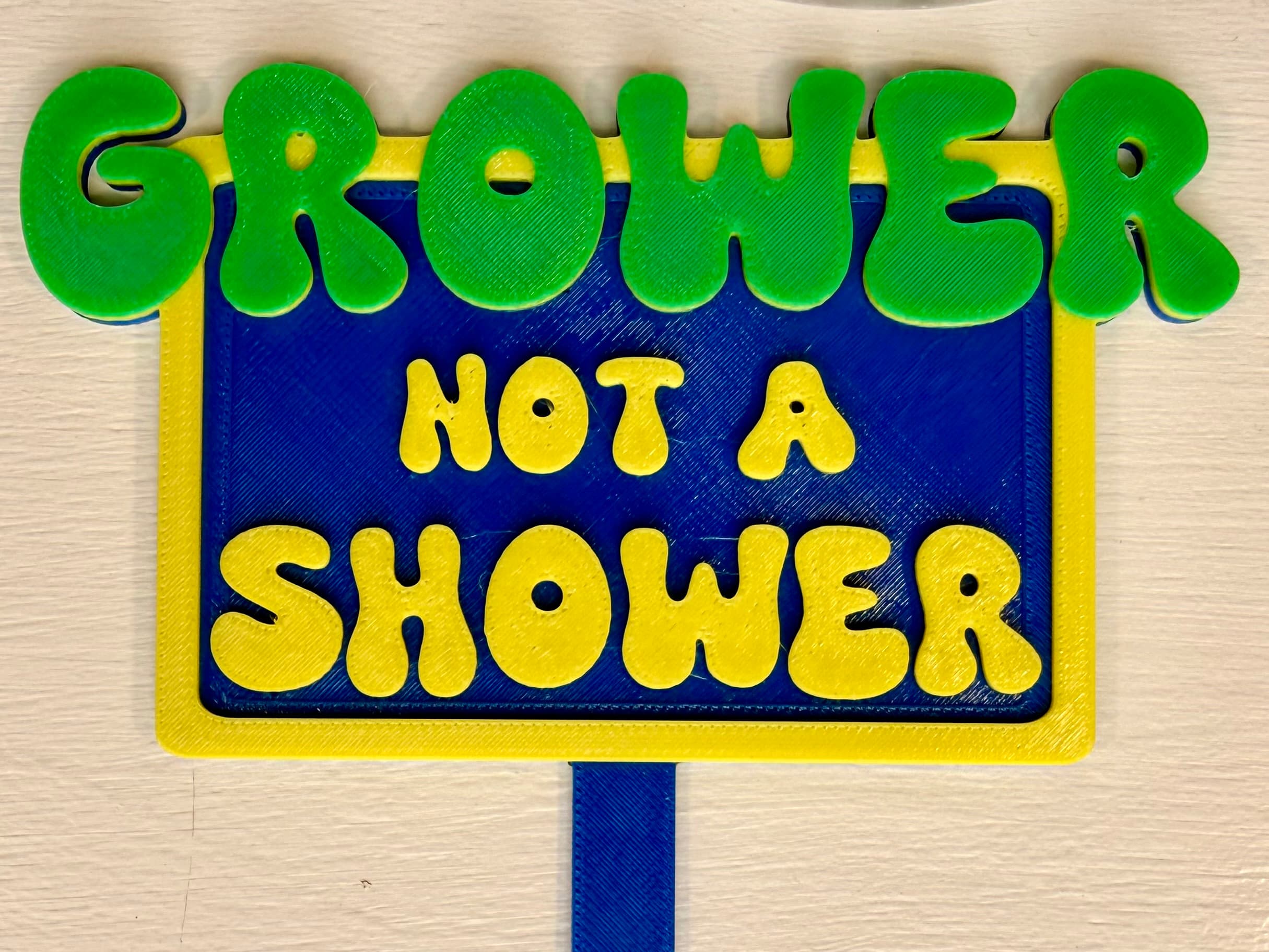 3D-printed pot pick with raised text reading 'Grower Not a Shower'