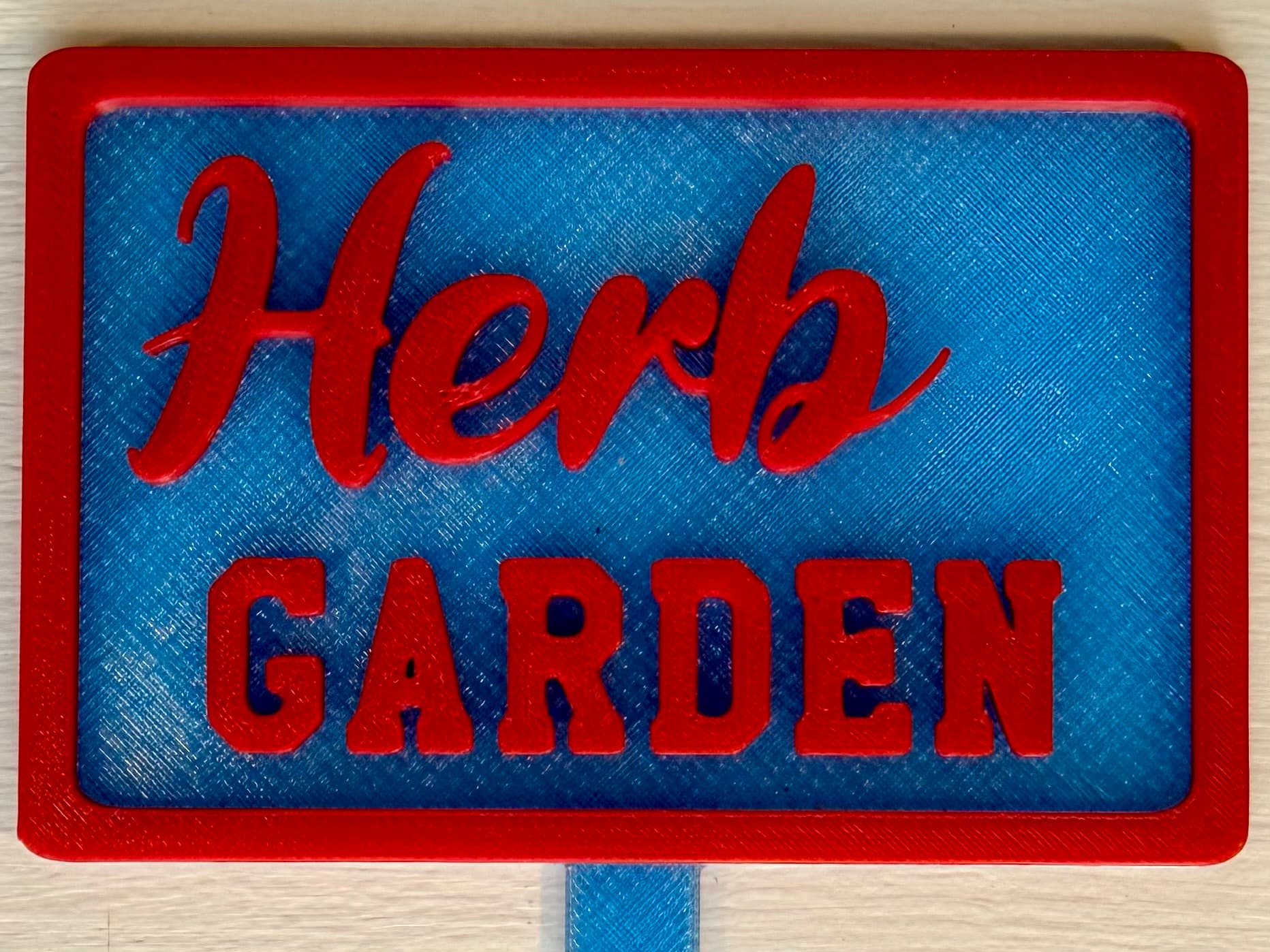 3D-printed pot pick with raised text reading 'Herb Garden'