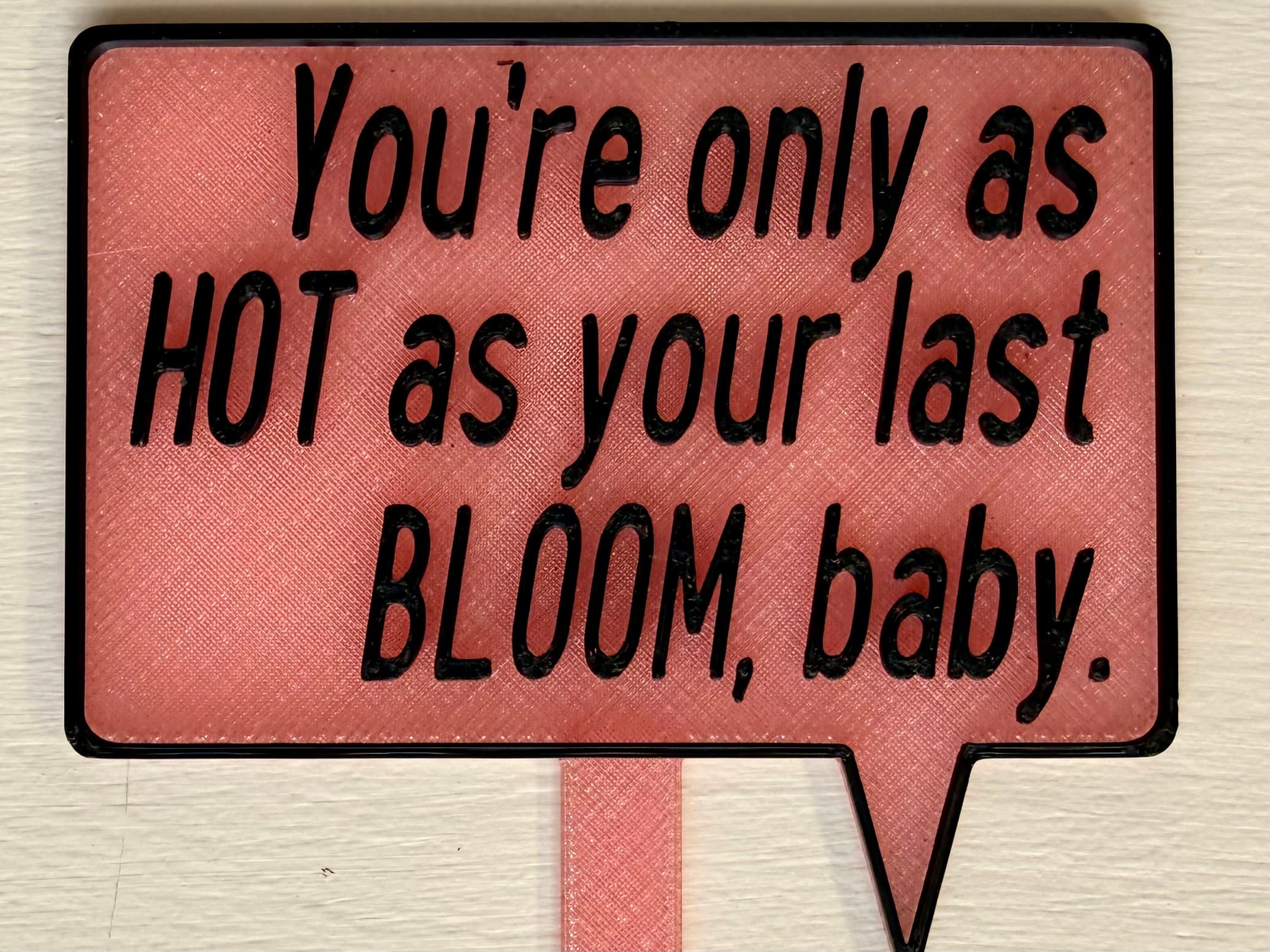 3D-printed pot pick with raised text reading 'You're Only as Hot as Your Last Bloom, Baby'