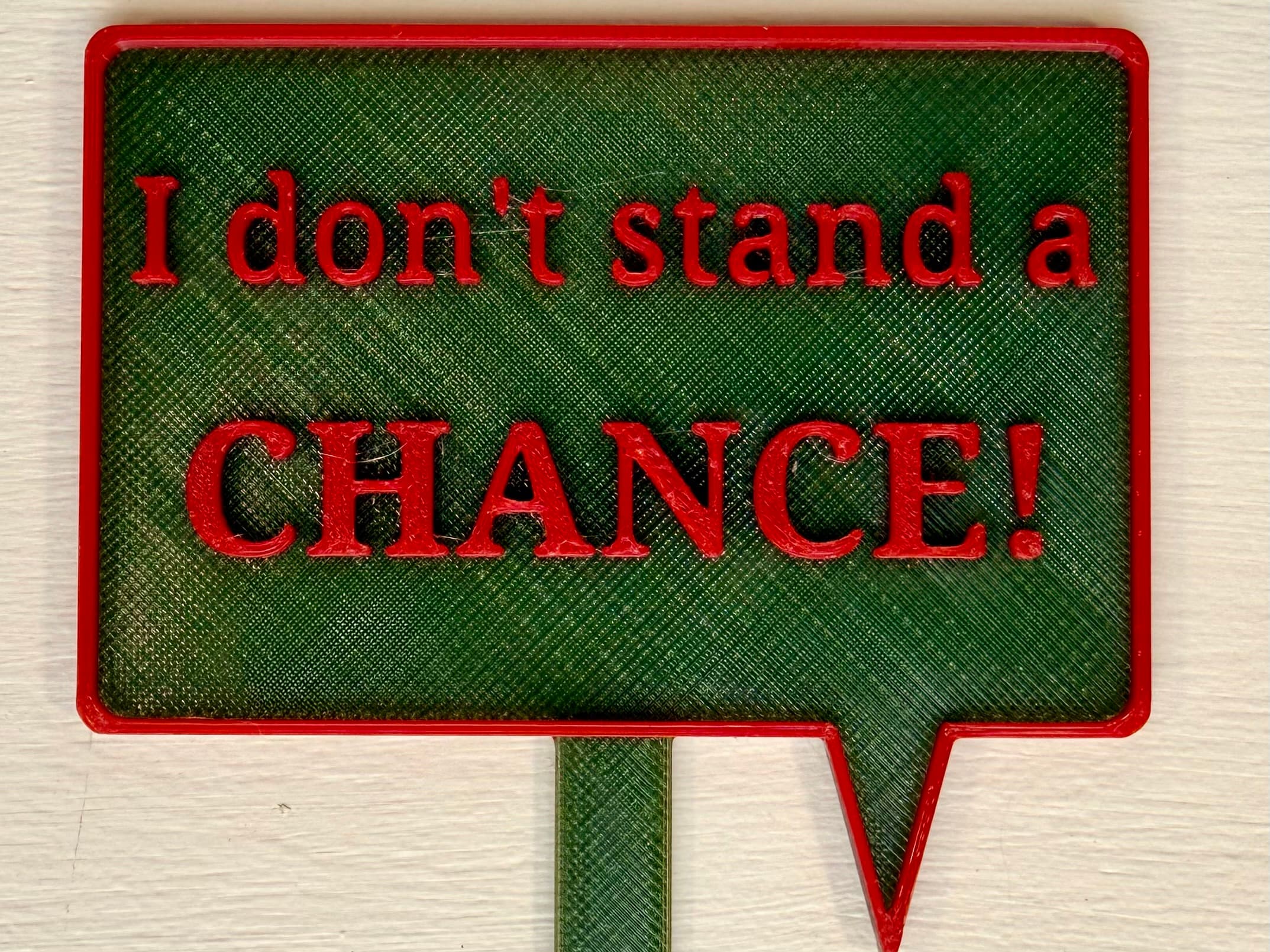 3D-printed pot pick with raised text reading 'I Don't Stand a Chance'