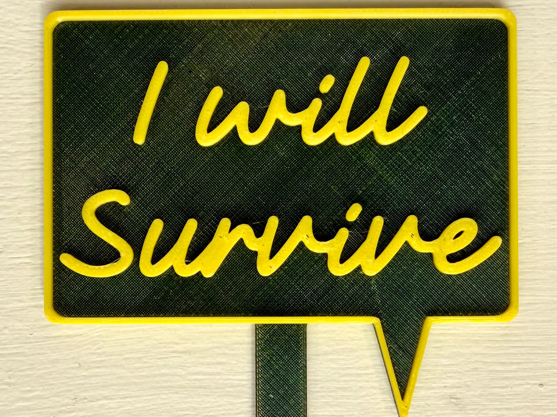 3D-printed pot pick with raised text reading 'I Will Survive'