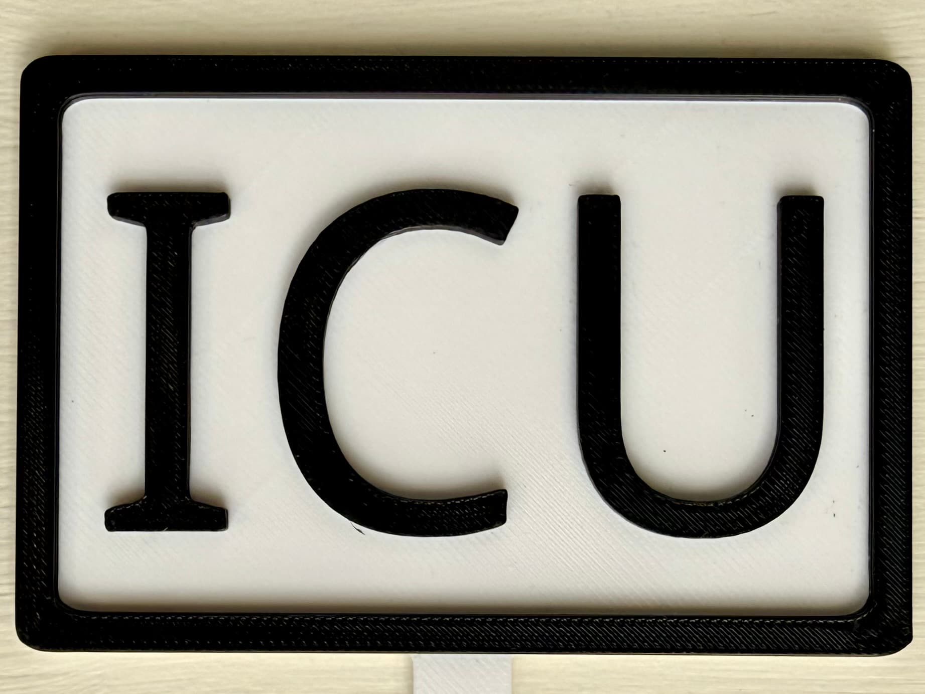 3D-printed pot pick with raised text reading 'ICU'