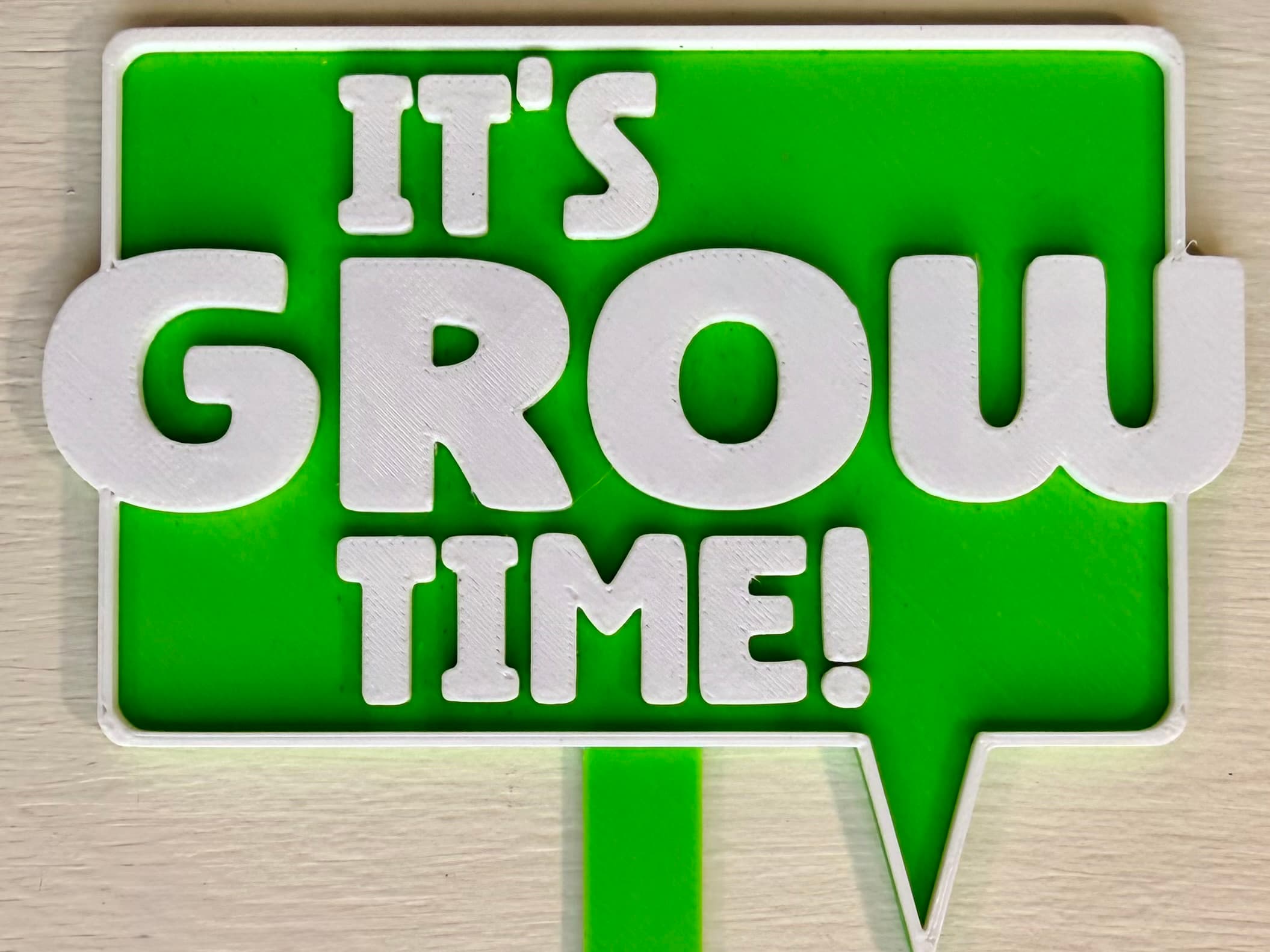 3D-printed pot pick with raised text reading 'It's Grow Time'