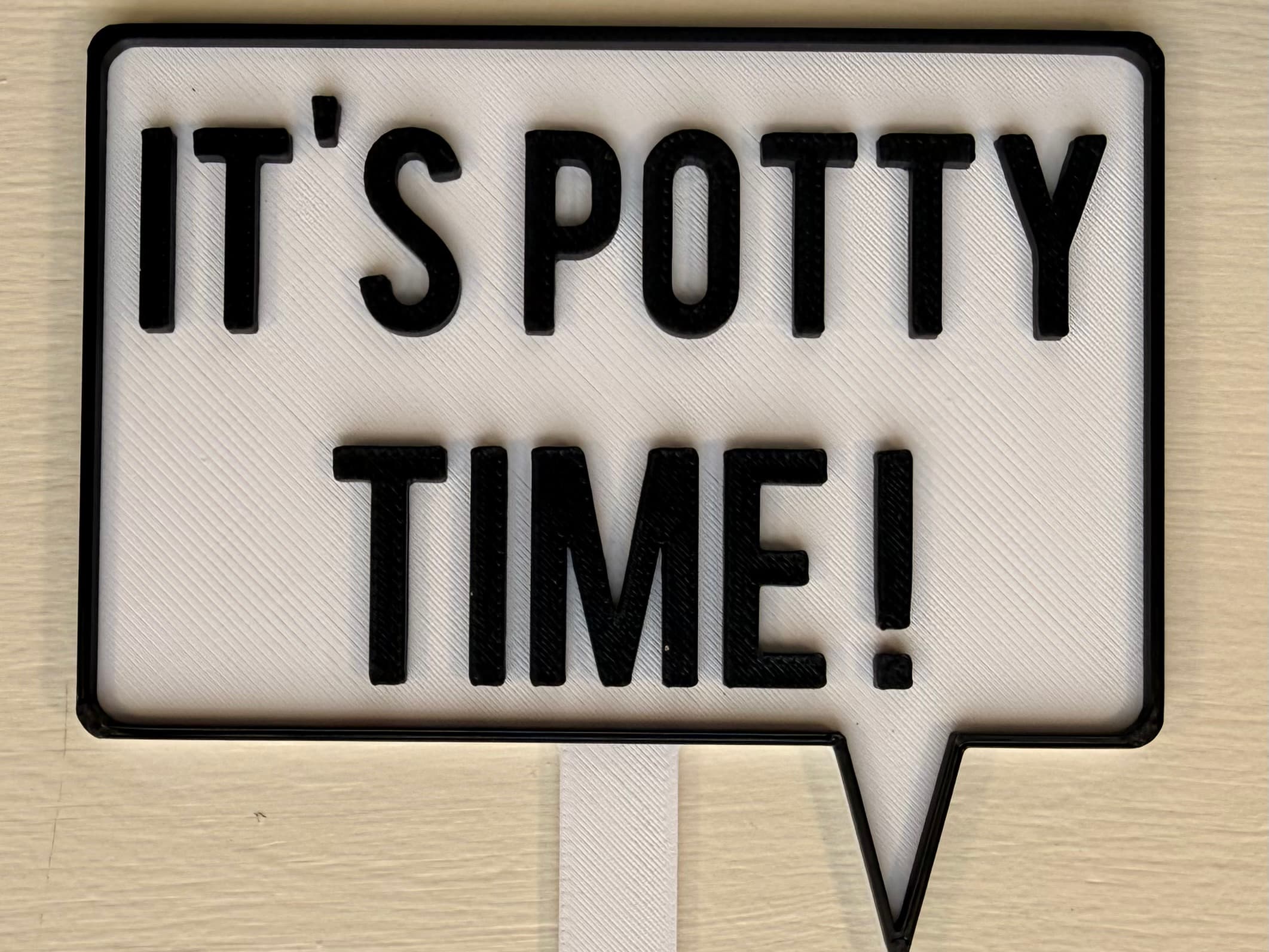 3D-printed pot pick with raised text reading 'It's Potty Time'