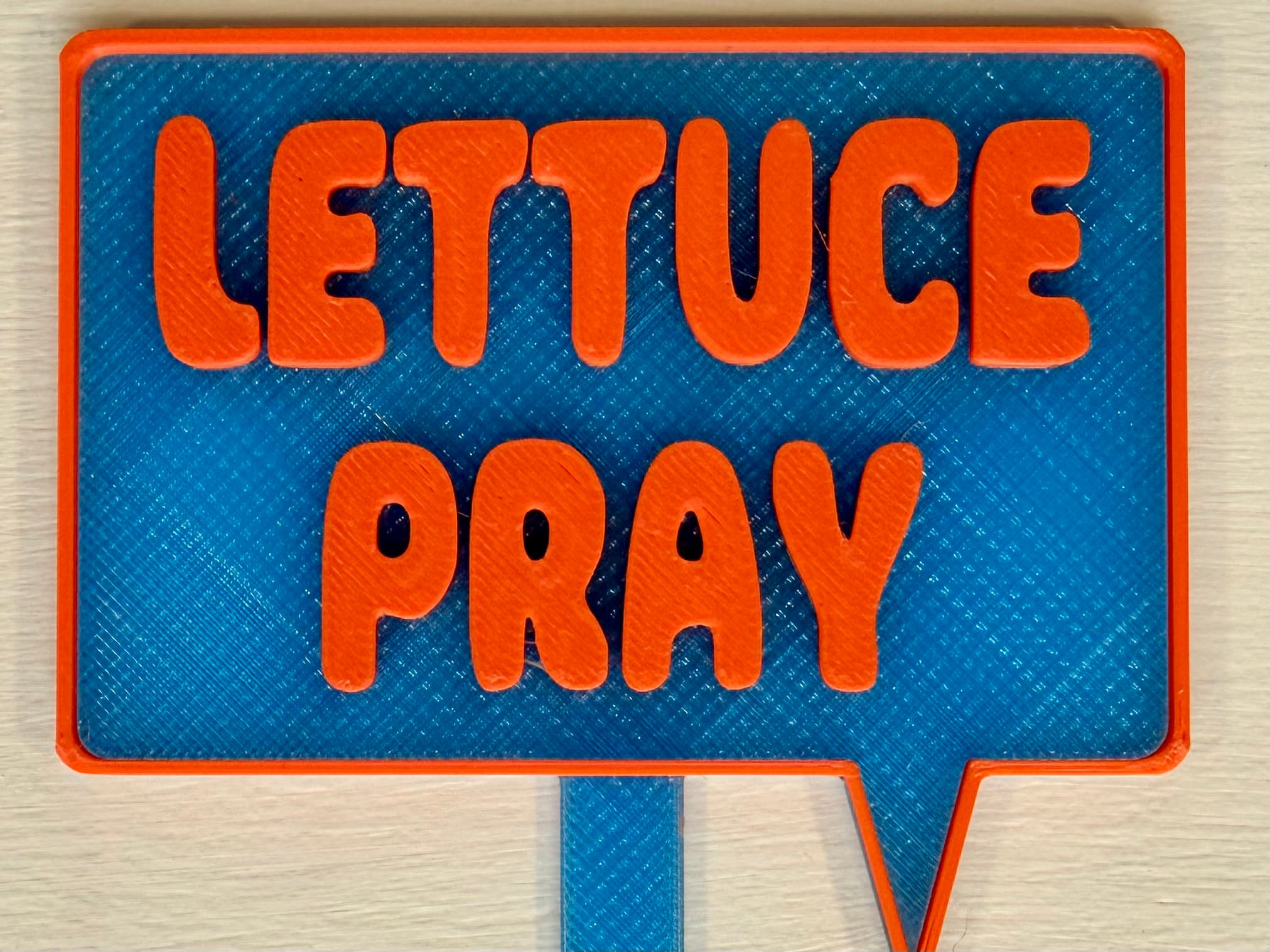3D-printed pot pick with raised text reading 'Lettuce Pray'