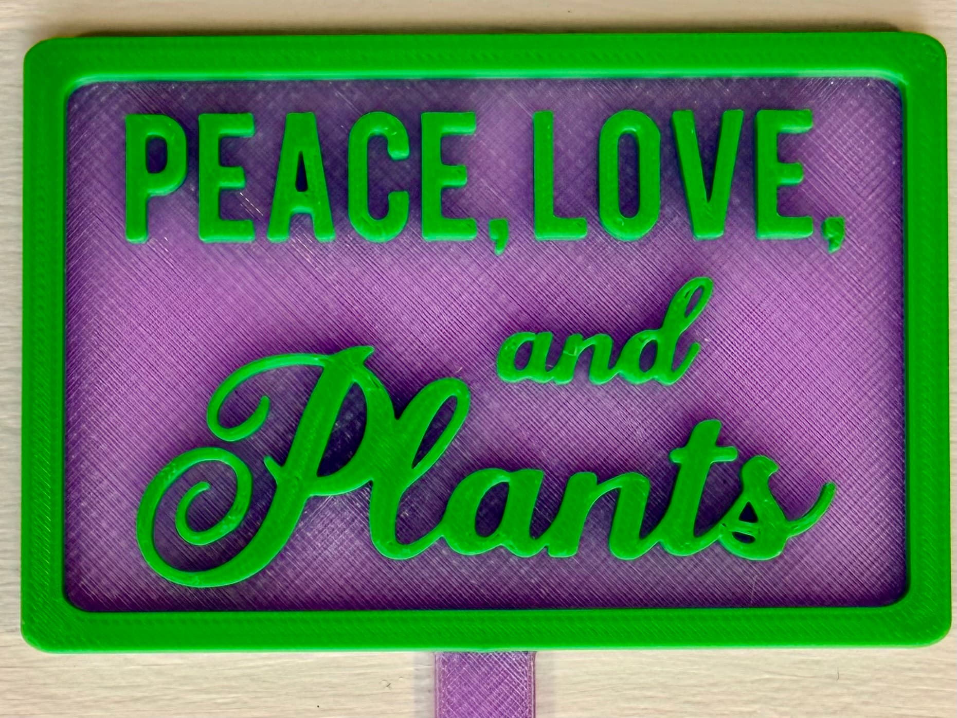 3D-printed pot pick with raised text reading 'Peace, Love, and Plants'