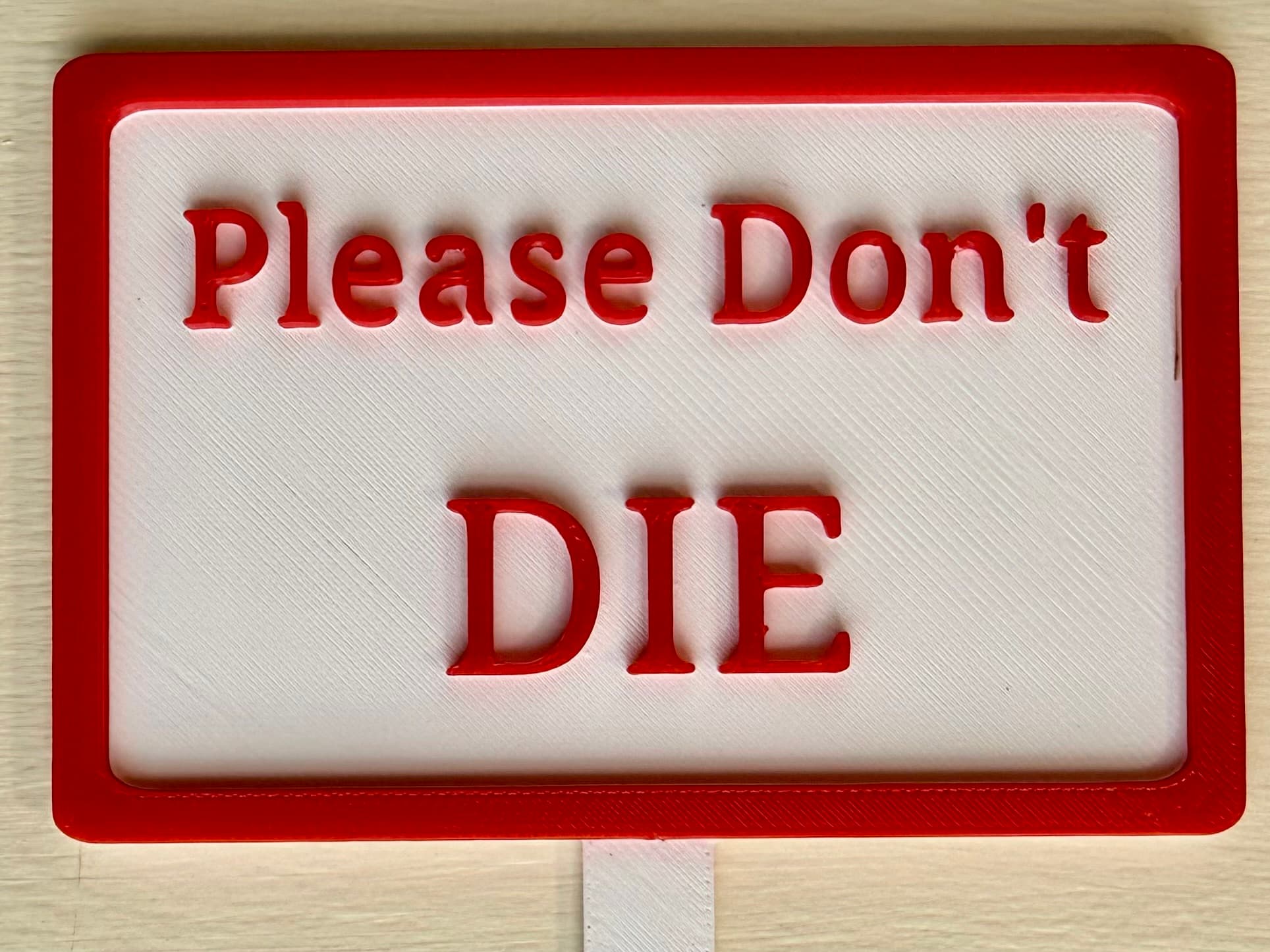 3D-printed pot pick with raised text reading 'Please Don't Die'