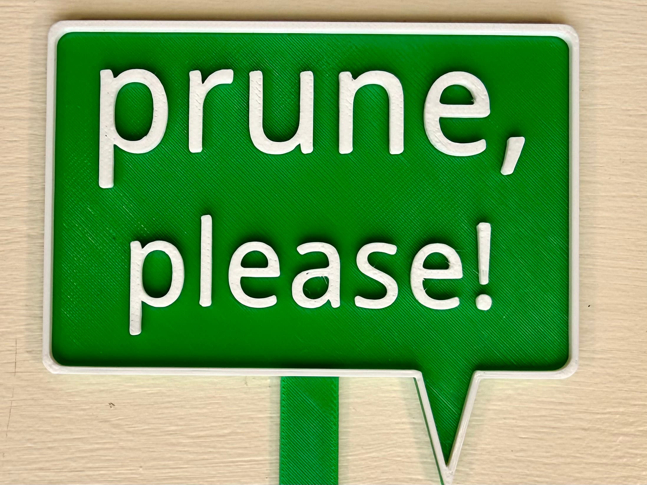 3D-printed pot pick with raised text reading 'Prune, Please'