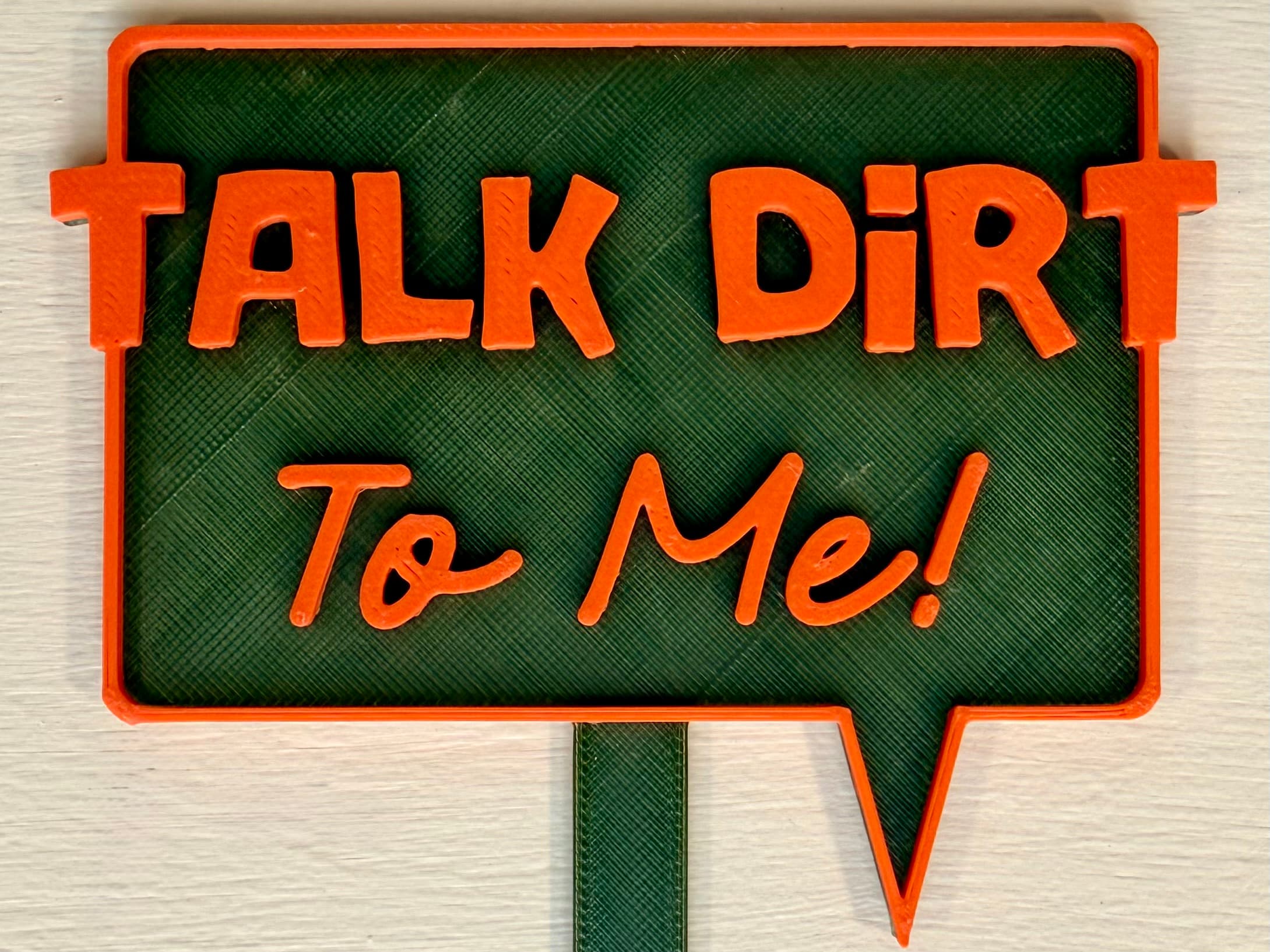 3D-printed pot pick with raised text reading 'Talk Dirt to Me'