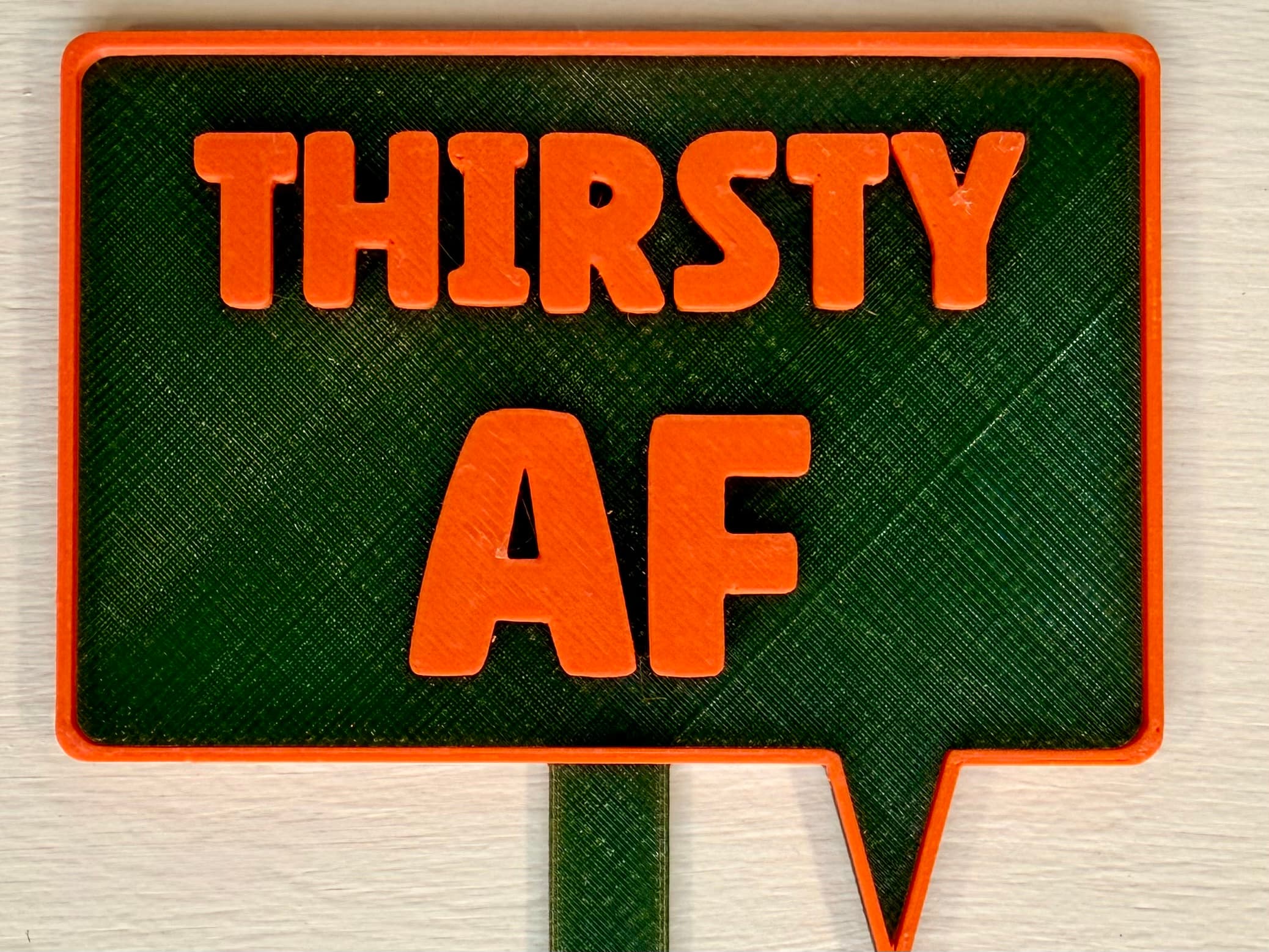 3D-printed pot pick with raised text reading 'Thirsty AF'