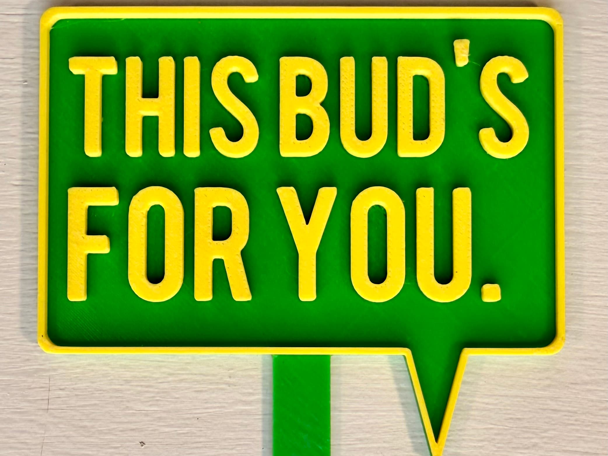 3D-printed pot pick with raised text reading 'This Buds for You'