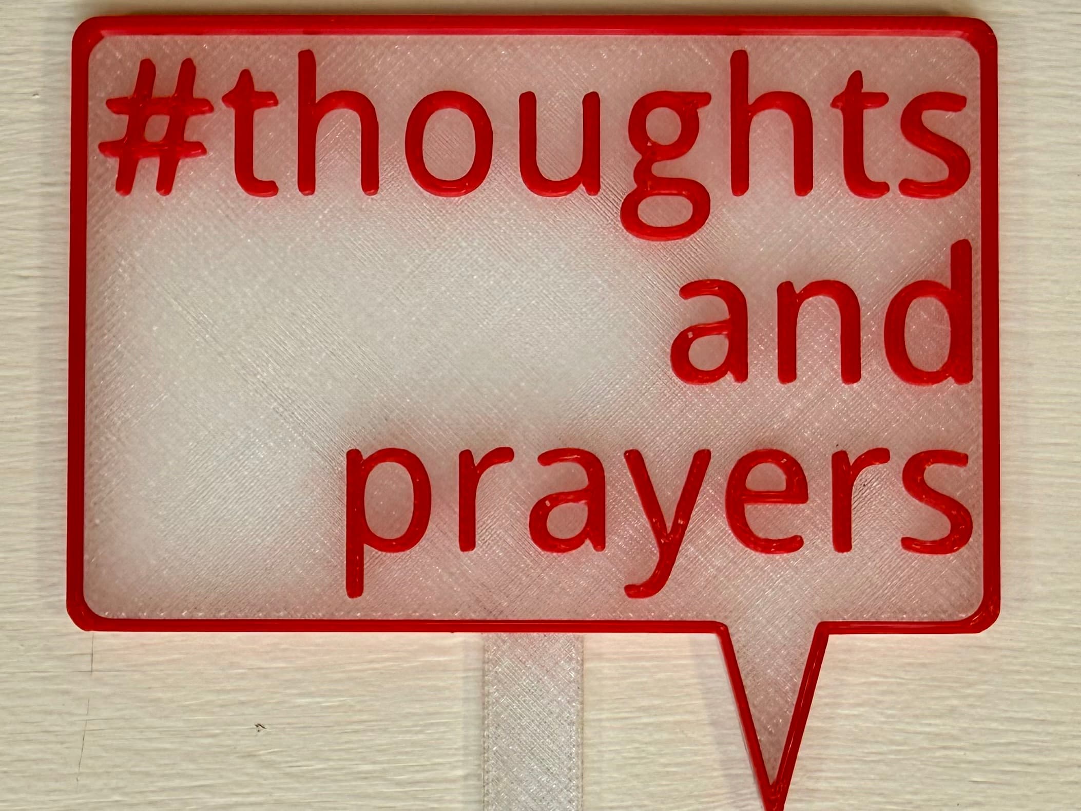 3D-printed pot pick with raised text reading '#ThoughtsAndPrayers'