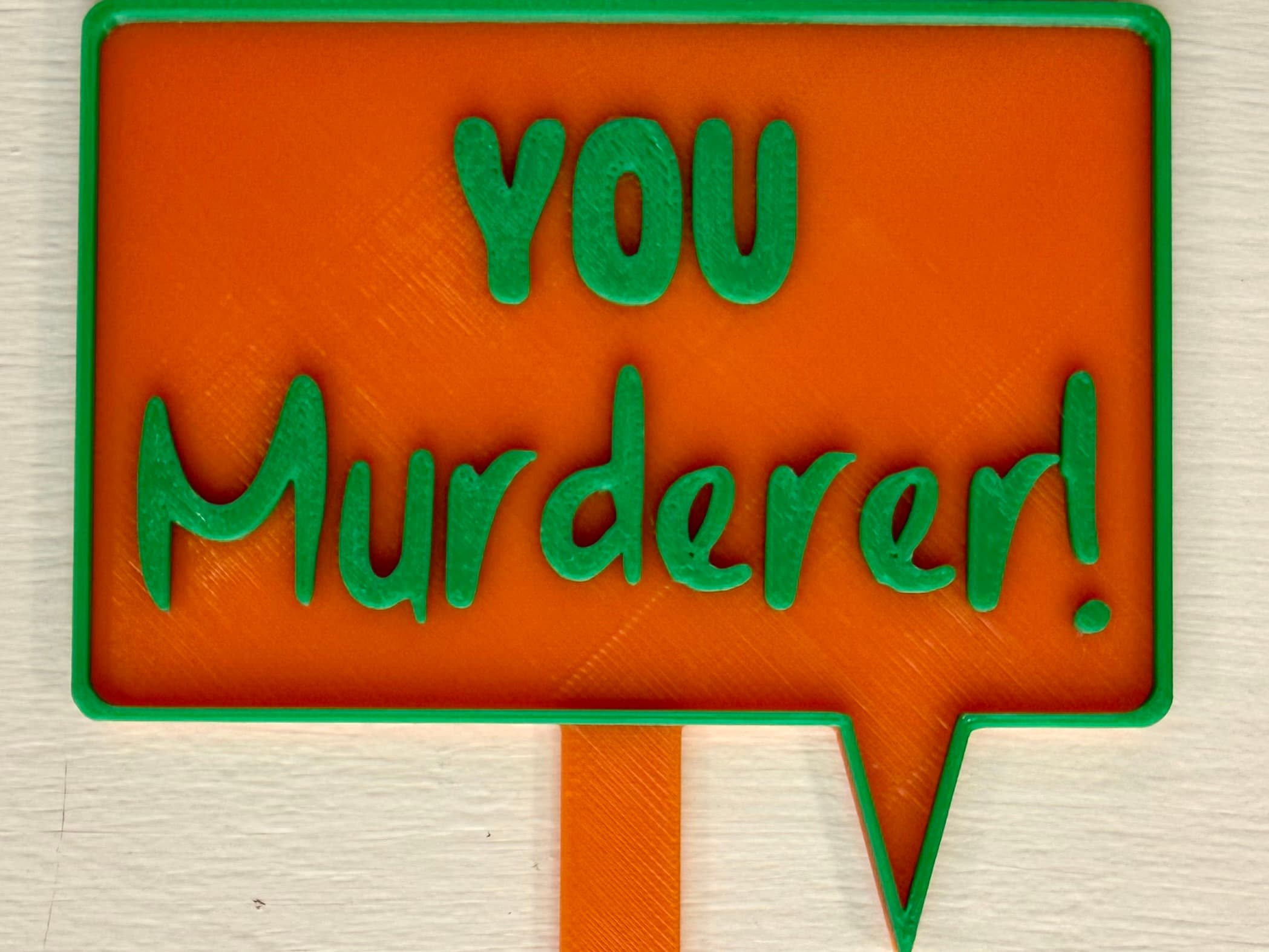 3D-printed pot pick with raised text reading 'You Murderer!'